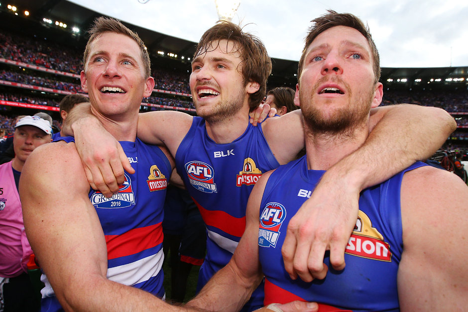 AFL 2016 Toyota AFL Grand Final - Sydney v Western Bulldogs MELBOURNE, AUSTRALIA - OCTOBER 01: Dale Morris of the Bulldogs (L) Joel Hamling (C) and Matthew Boyd celebrates the win during the 2016 Toyota AFL Grand Final match between the Sydney Swans and the Western Bulldogs at the Melbourne Cricket Ground on October 01, 2016 in Melbourne, Australia. (Photo by Michael Dodge/AFL Media)